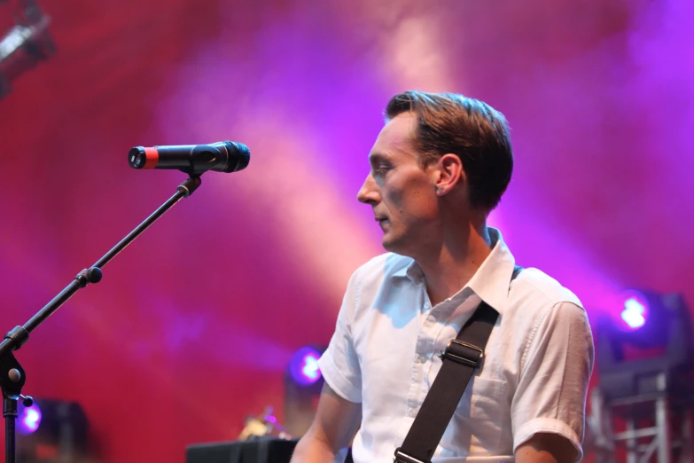 a man is playing on the keyboard with a microphone