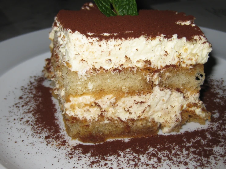 a piece of layered cake sitting on top of a white plate