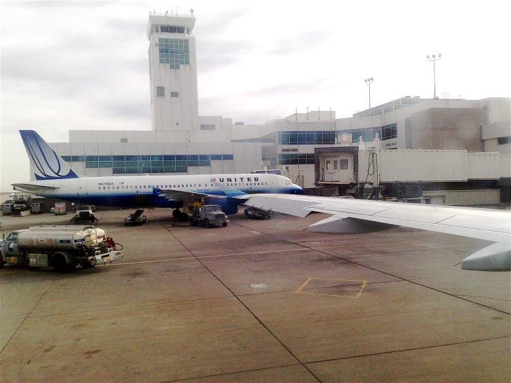 large commercial airliner parked at an airport gate