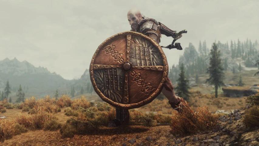 a large warrior holding a shield and axe stands on a hill
