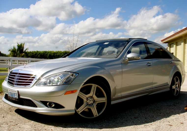 a silver car parked in front of a yellow building