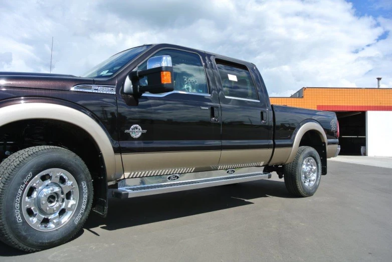 a black and gold truck parked in a lot