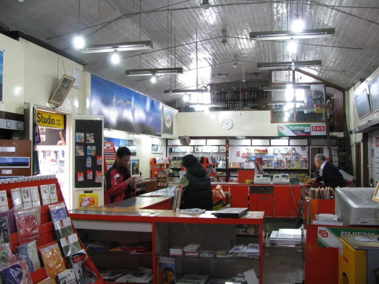 a woman at a cash register with people shopping