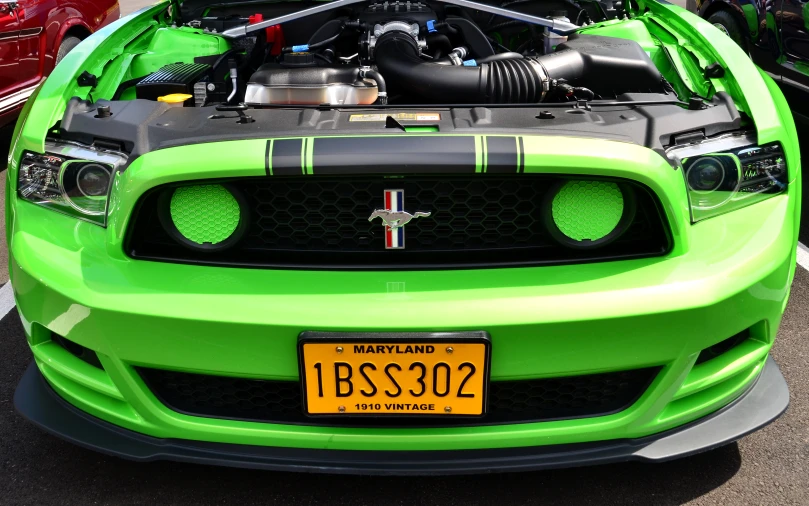 the sports car is green with black stripes