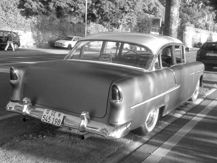 an old style car on the street during the day