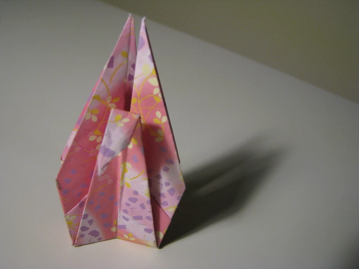 a pink paper vase made to look like a pyramid