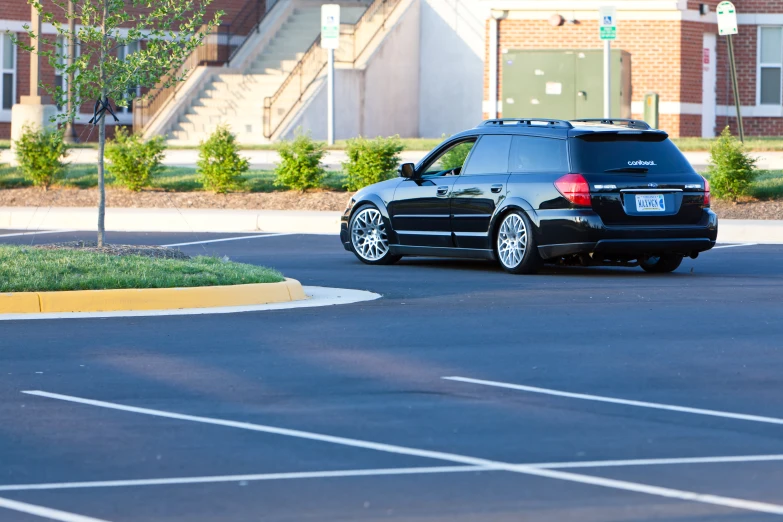 a black bmw vehicle sits in the parking lot