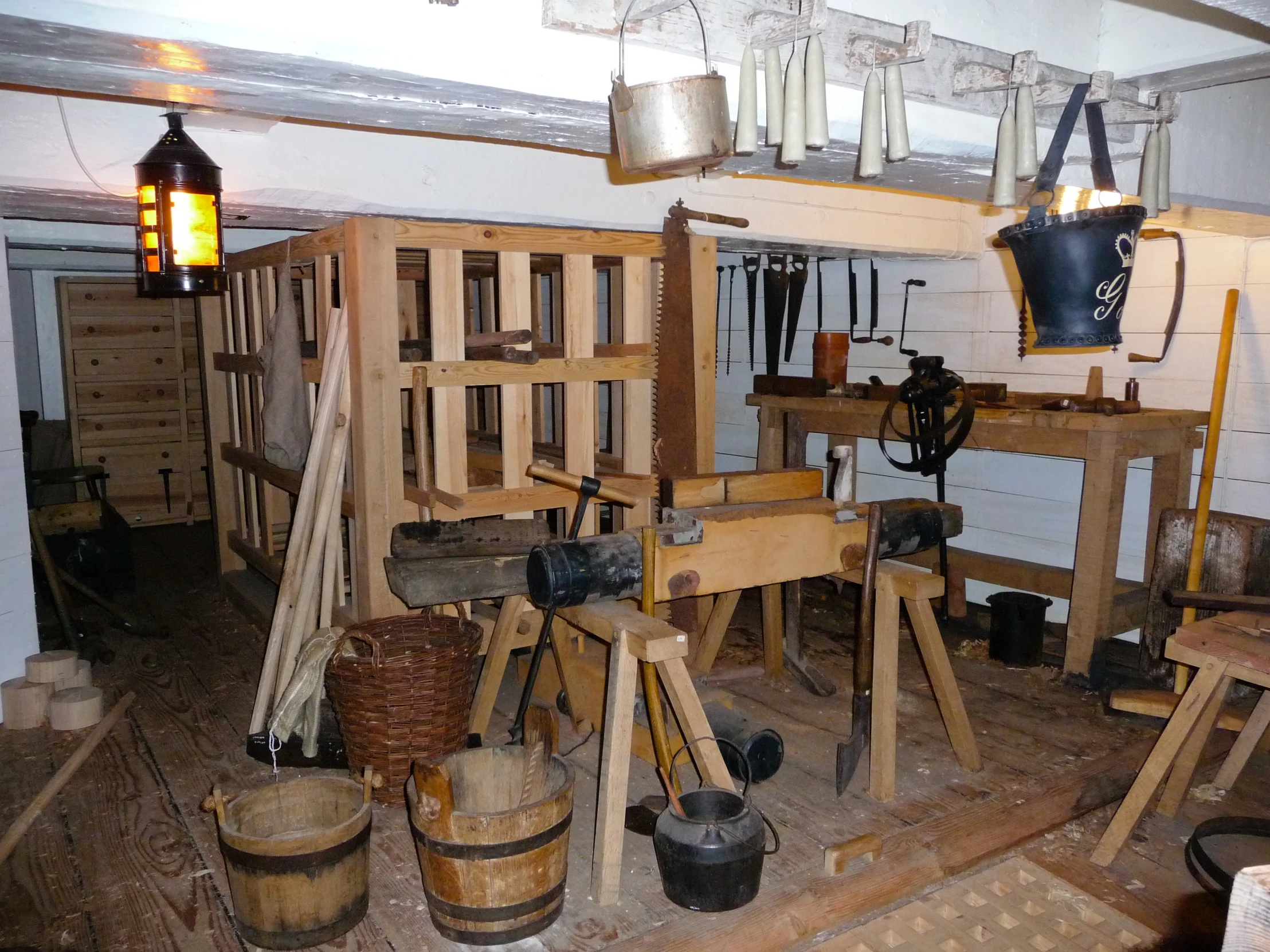 the building has wood pallets lined up with tools and buckets