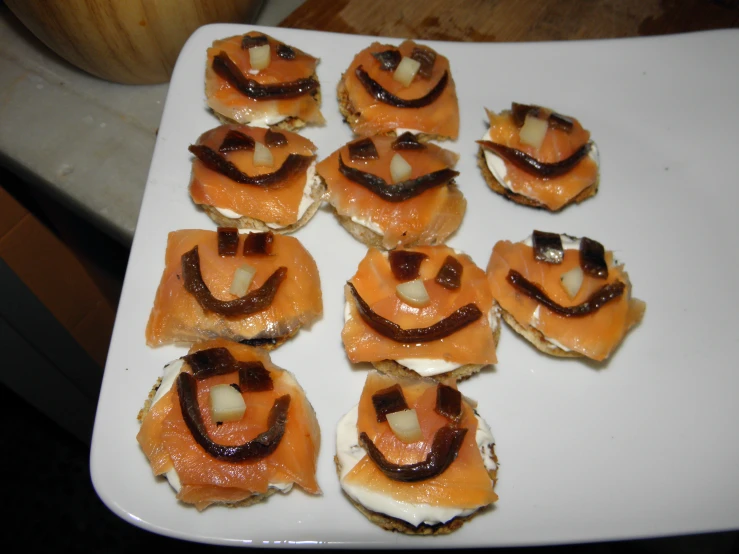 a square white plate with many small appetizers