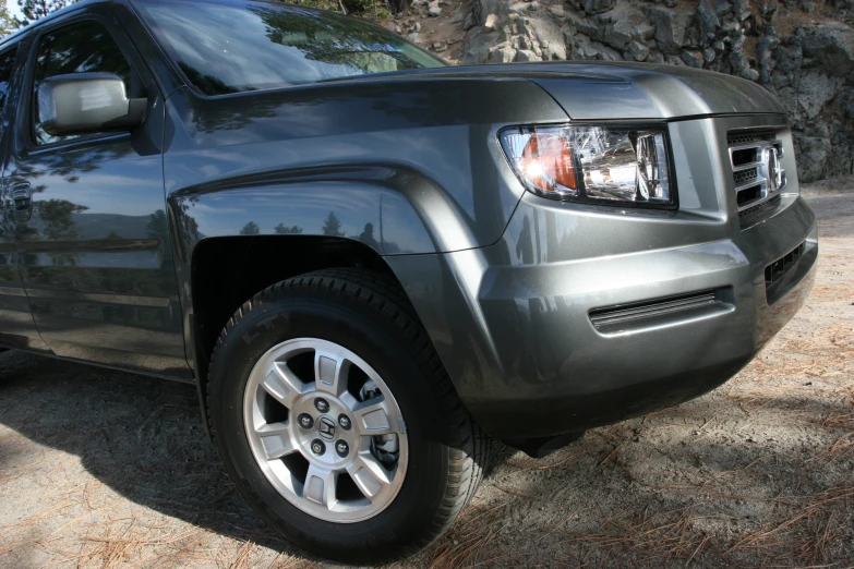 a vehicle parked in front of a rock wall