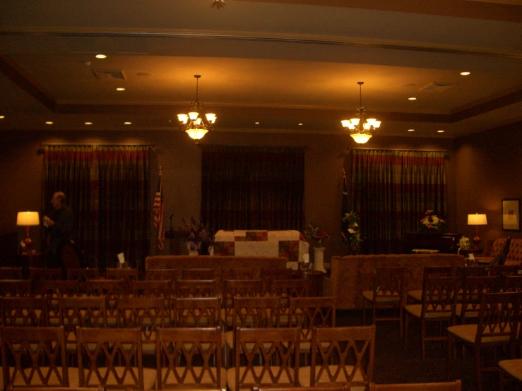 a couple of chandeliers hanging from the ceiling of an empty room