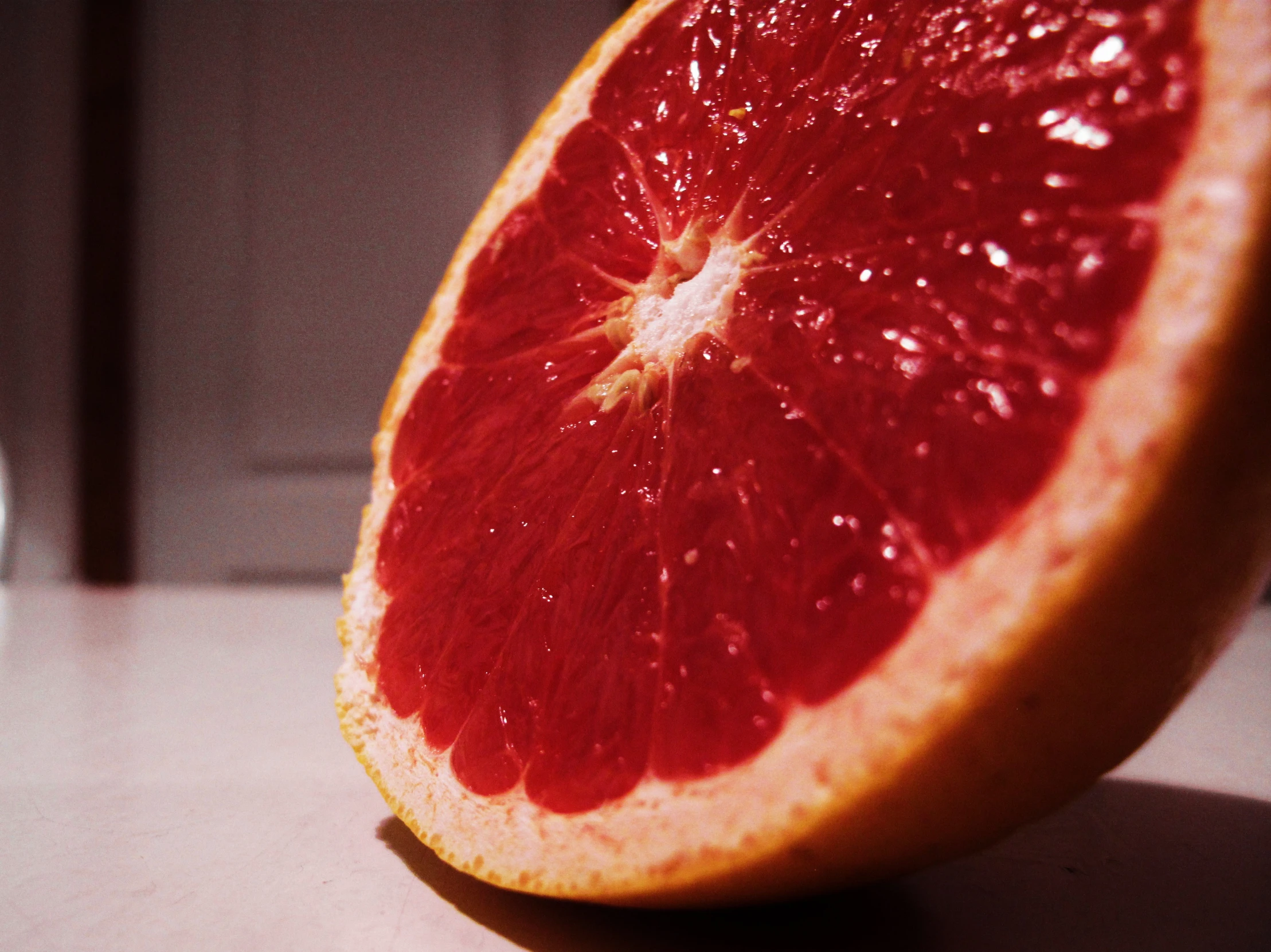 a red gfruit cut in half sitting on a table