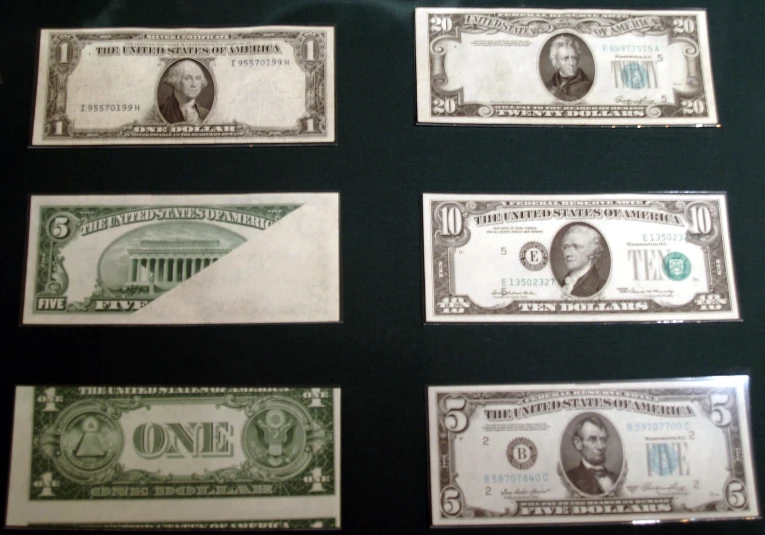 five different bank notes are placed on display