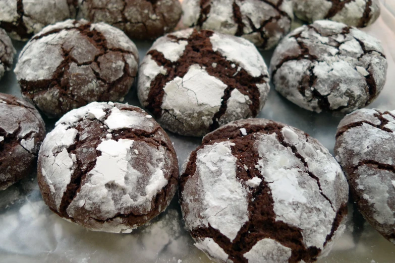 a plate of cookies are covered in powdered sugar