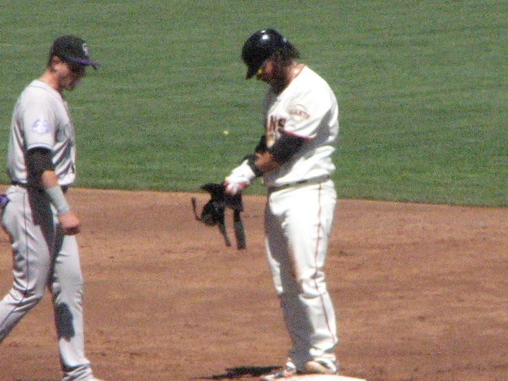 a player is standing in a batter's box talking to one