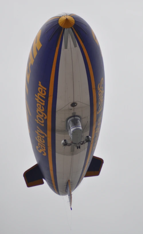 an air ballon flying through a cloudy gray sky