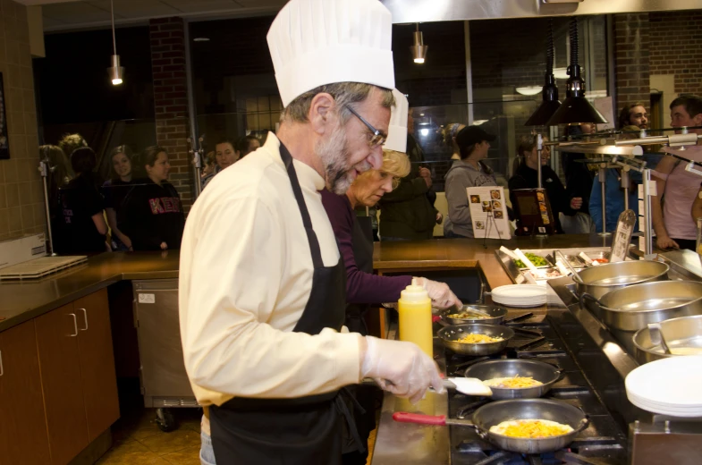 two chefs making a meal in the kitchen