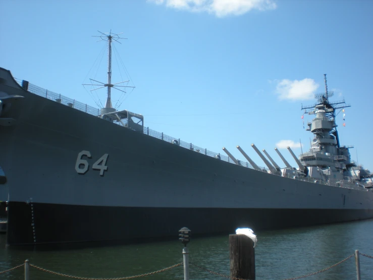 the large ship is anchored at the pier