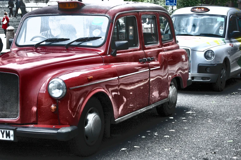 an old car and a van in a busy street