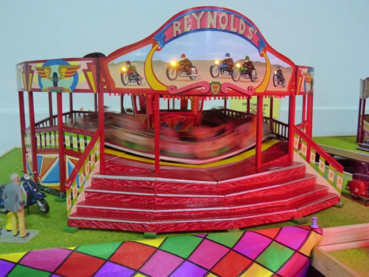 a carnival ride sitting on top of a green field