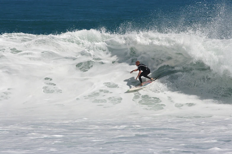 a surfer rides a wave in the ocean