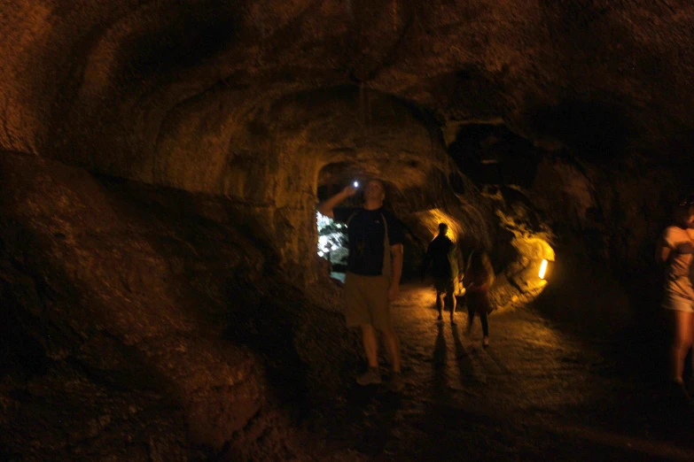 people walking through a cave in the dark