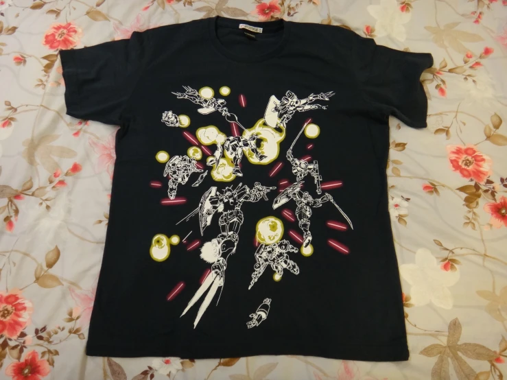 black tee - shirt with white and yellow designs on it