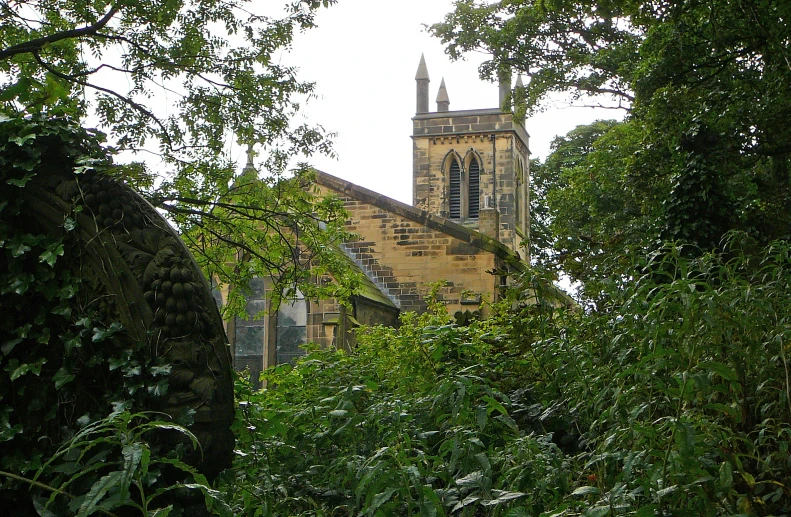 an old stone church sitting next to some trees