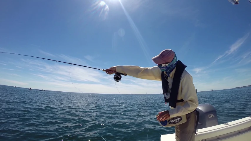 a man is fishing on a boat in the ocean