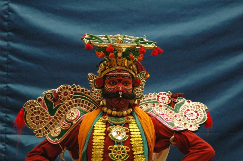 this image shows a man in costume with masks on his face