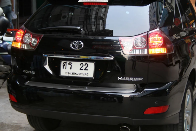 rear view of black toyota highland sport with license plate