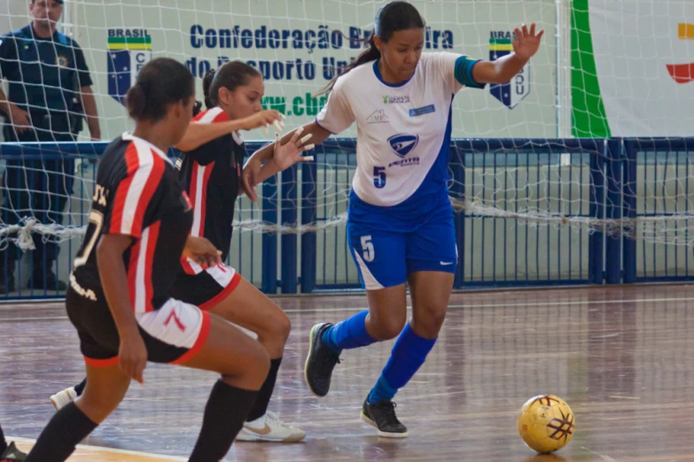 a group of women playing soccer against each other