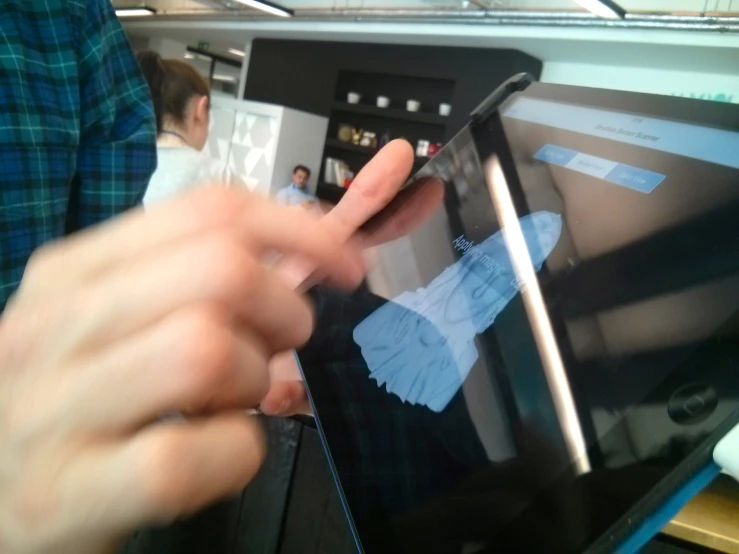 a person holding a small ipad displaying some images