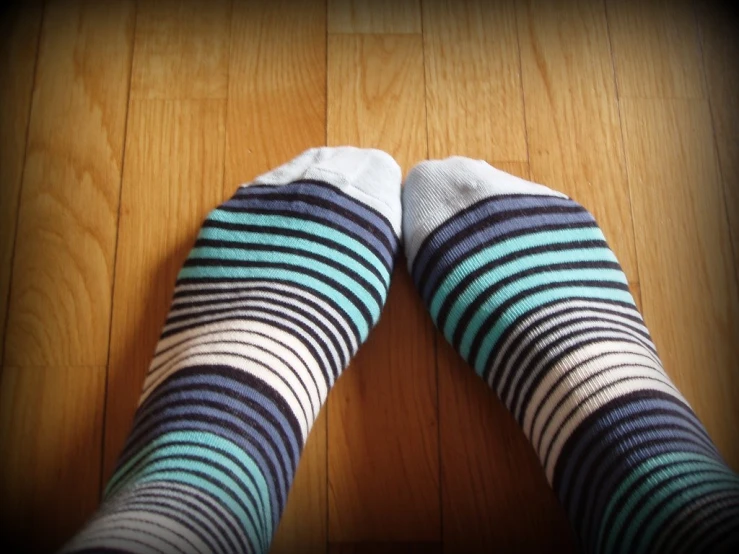 a person in striped socks is seen from above