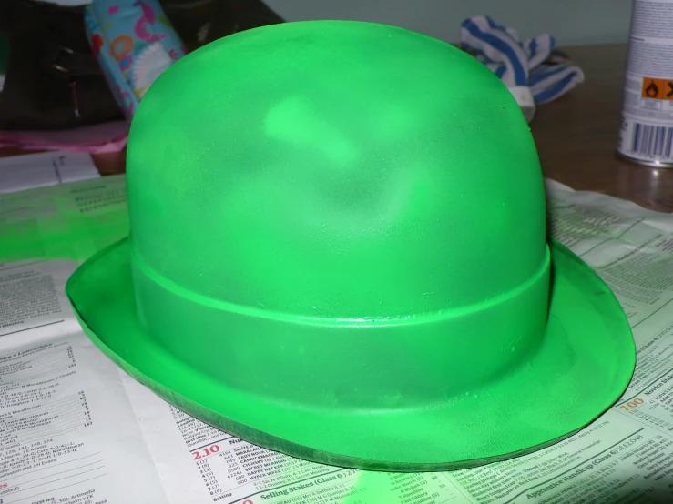 a bright green hat on top of some papers