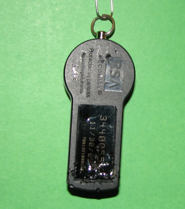 an old fashioned metal keychain on a green table