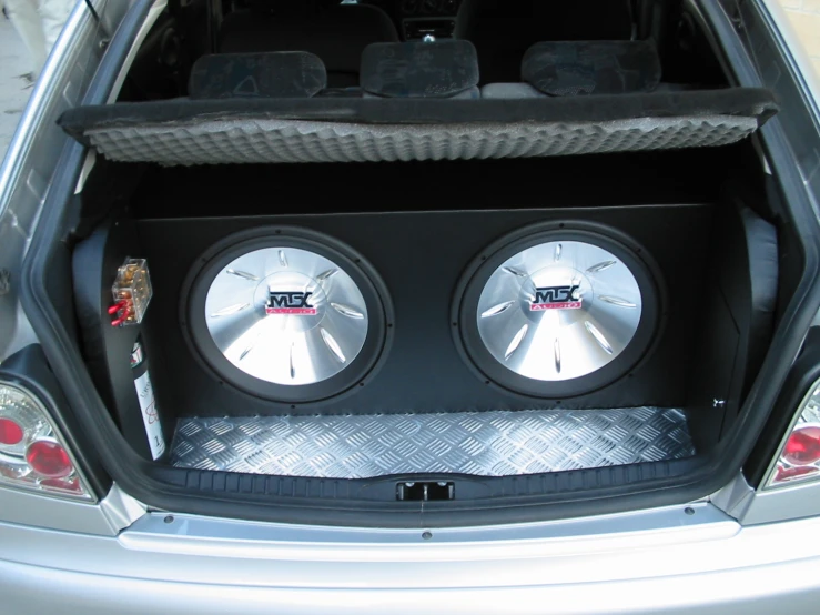 two sub speakers installed into the trunk of a car