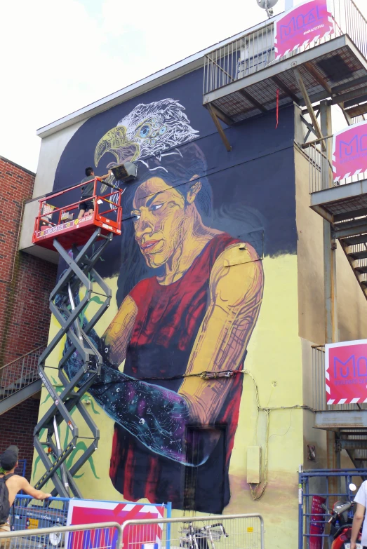 a mural of a basketball player is painted on the side of a building
