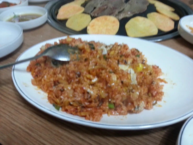 some food on a plate and some trays of potato chips