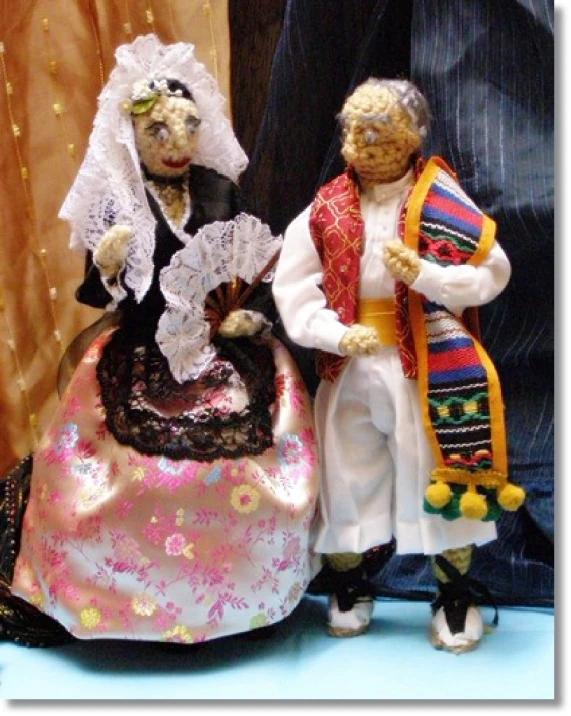 this is an image of two dolls dressed in costumes