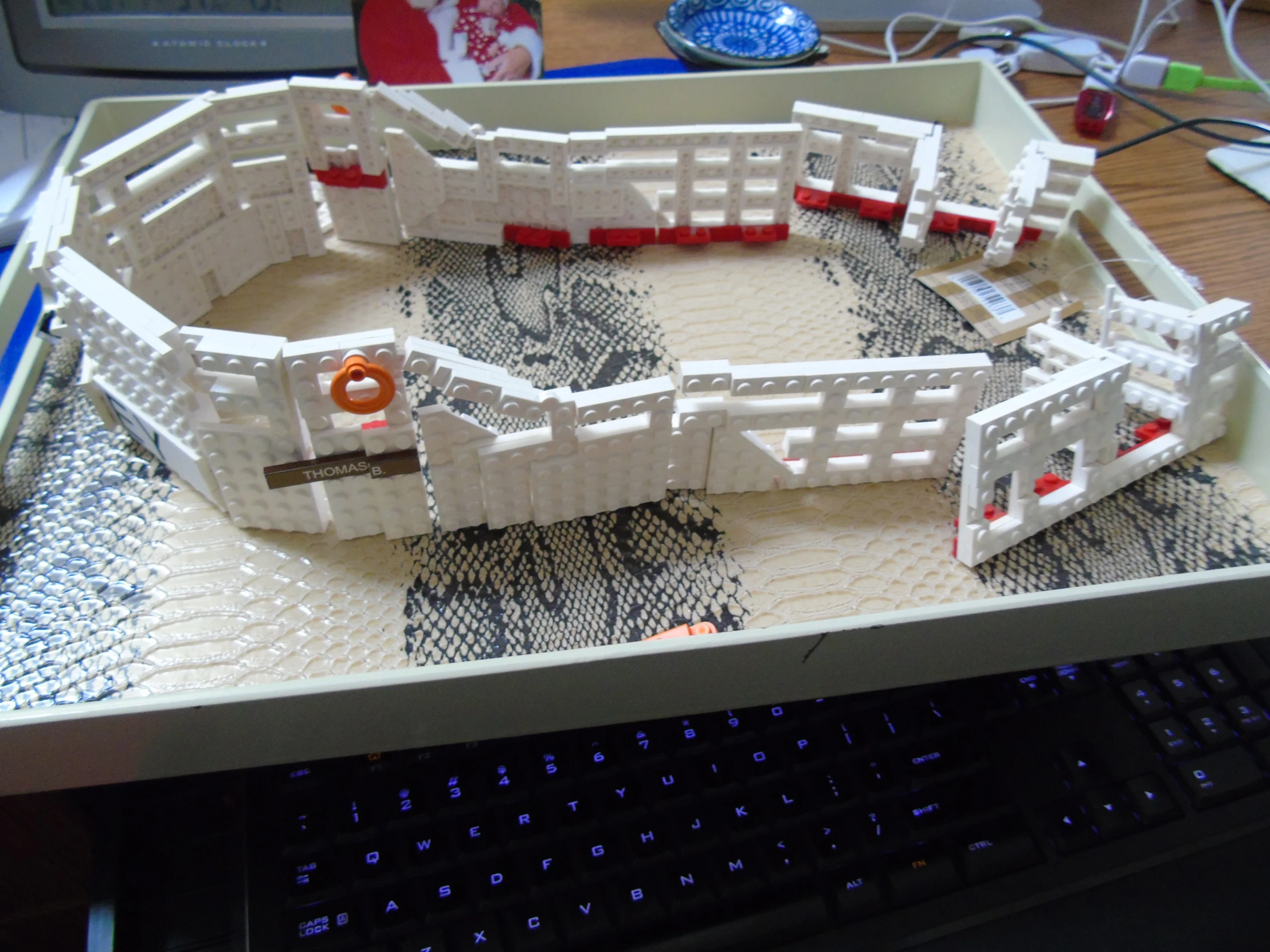 a very long plastic castle set on a computer keyboard