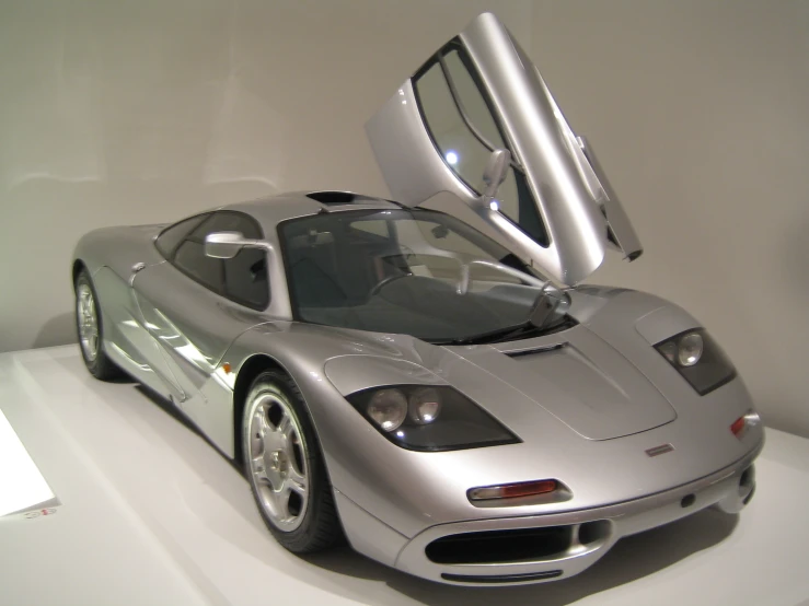 an expensive sports car on display with its doors open