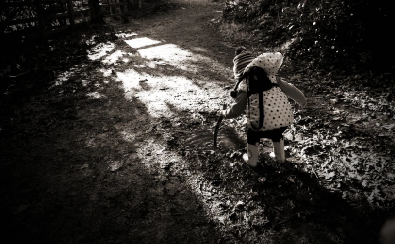 a child is dressed in white and a polka dot shirt with a hat on