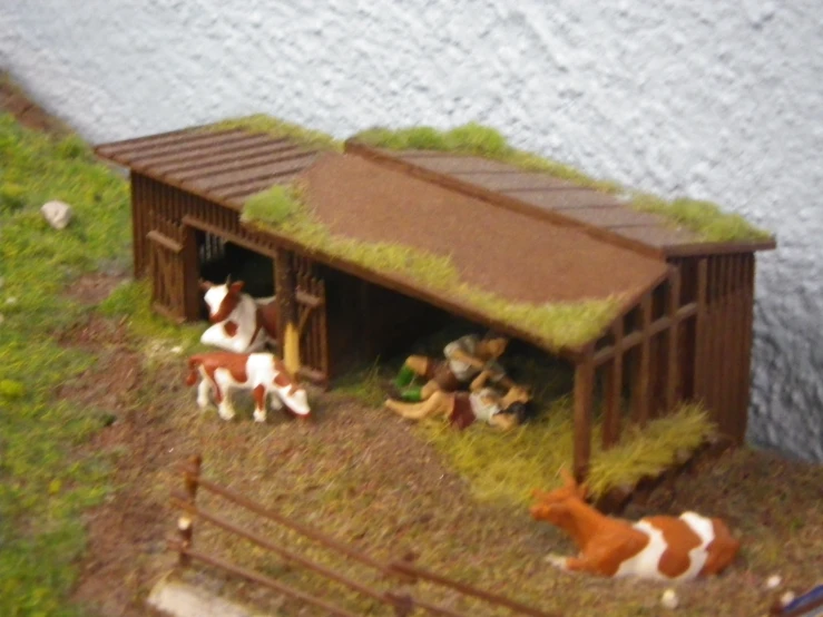 a wooden stable with fake horses in it