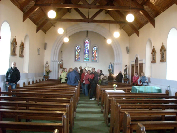 large group of people in a church with pews