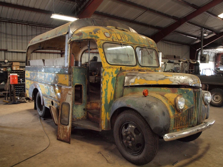 an old van is parked inside a warehouse