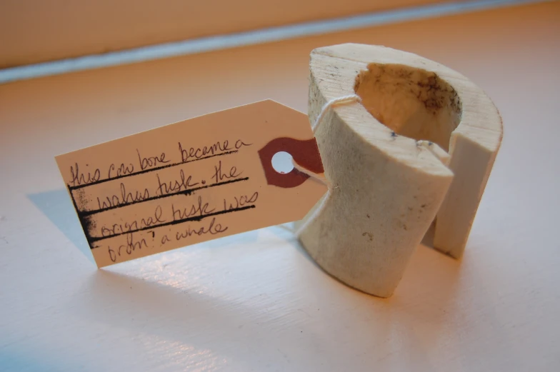 a broken toothbrush holder with a note