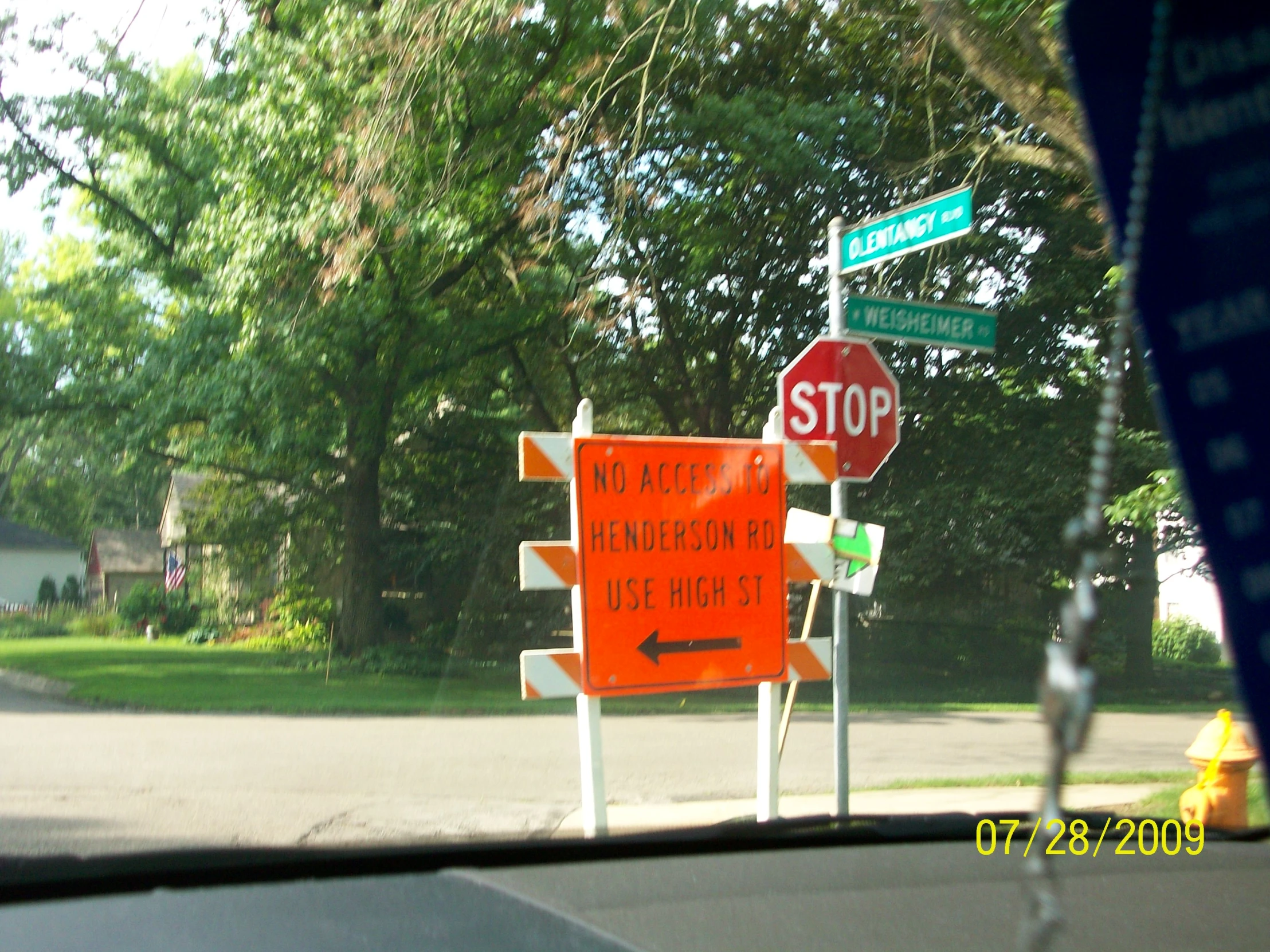 a traffic sign has been knocked over by street signs