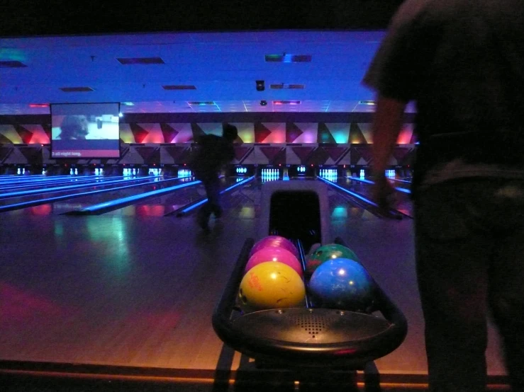 two men are going bowling down the alley