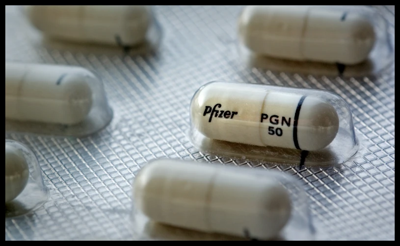 two pills on a table in pill caps